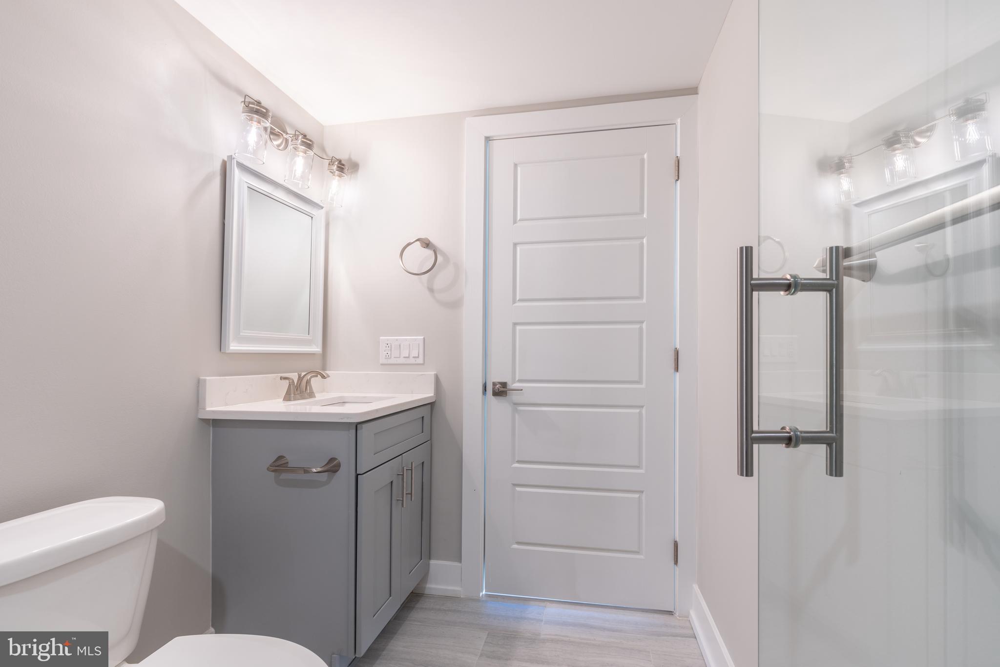 2517 Hope Street, Unit 5 Philadelphia, PA 19133 - Photo 15 of 35 a bathroom with a sink a toilet a mirror and shower