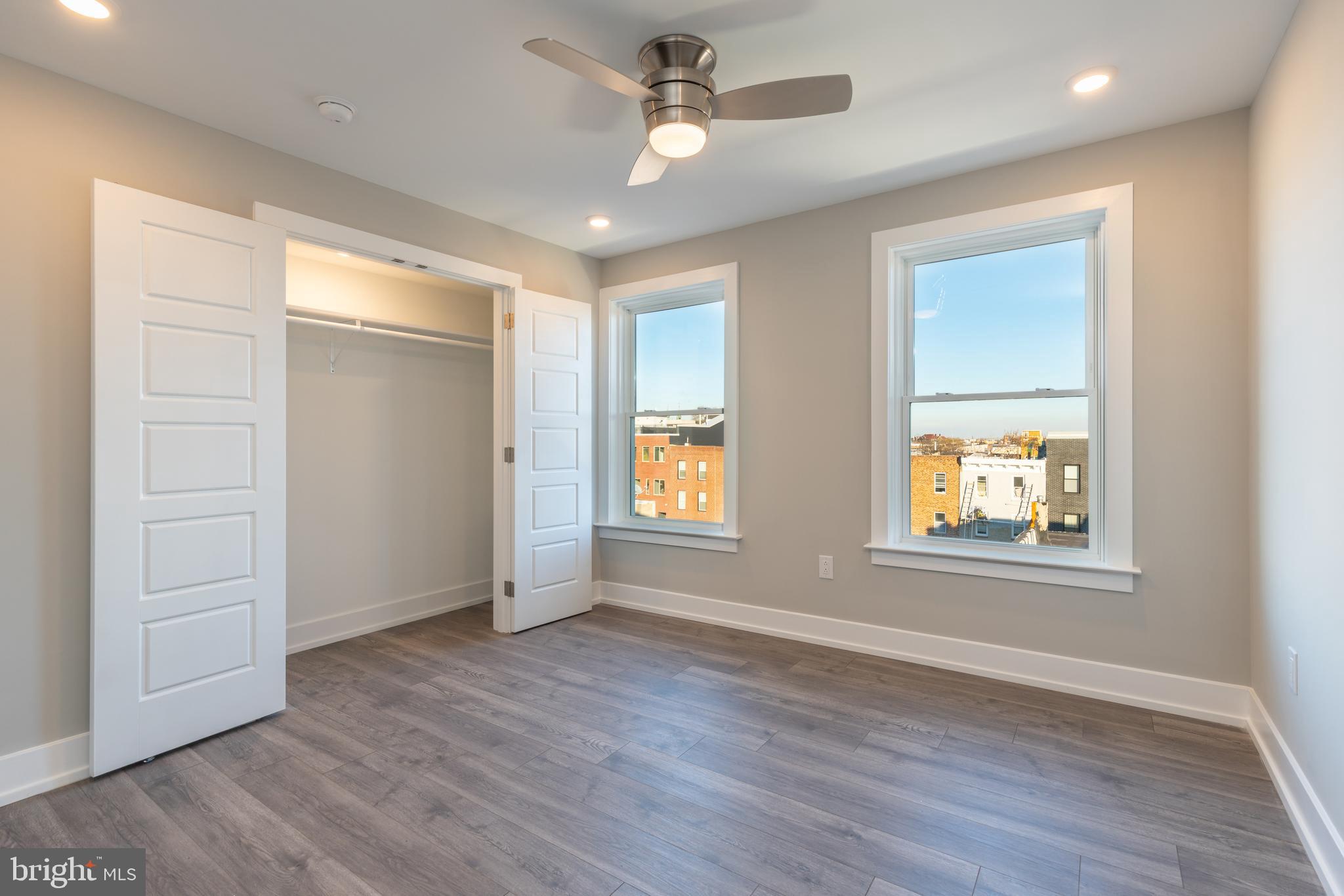 2517 Hope Street, Unit 5 Philadelphia, PA 19133 - Photo 17 of 35 an empty room with wooden floor ceiling fan and windows