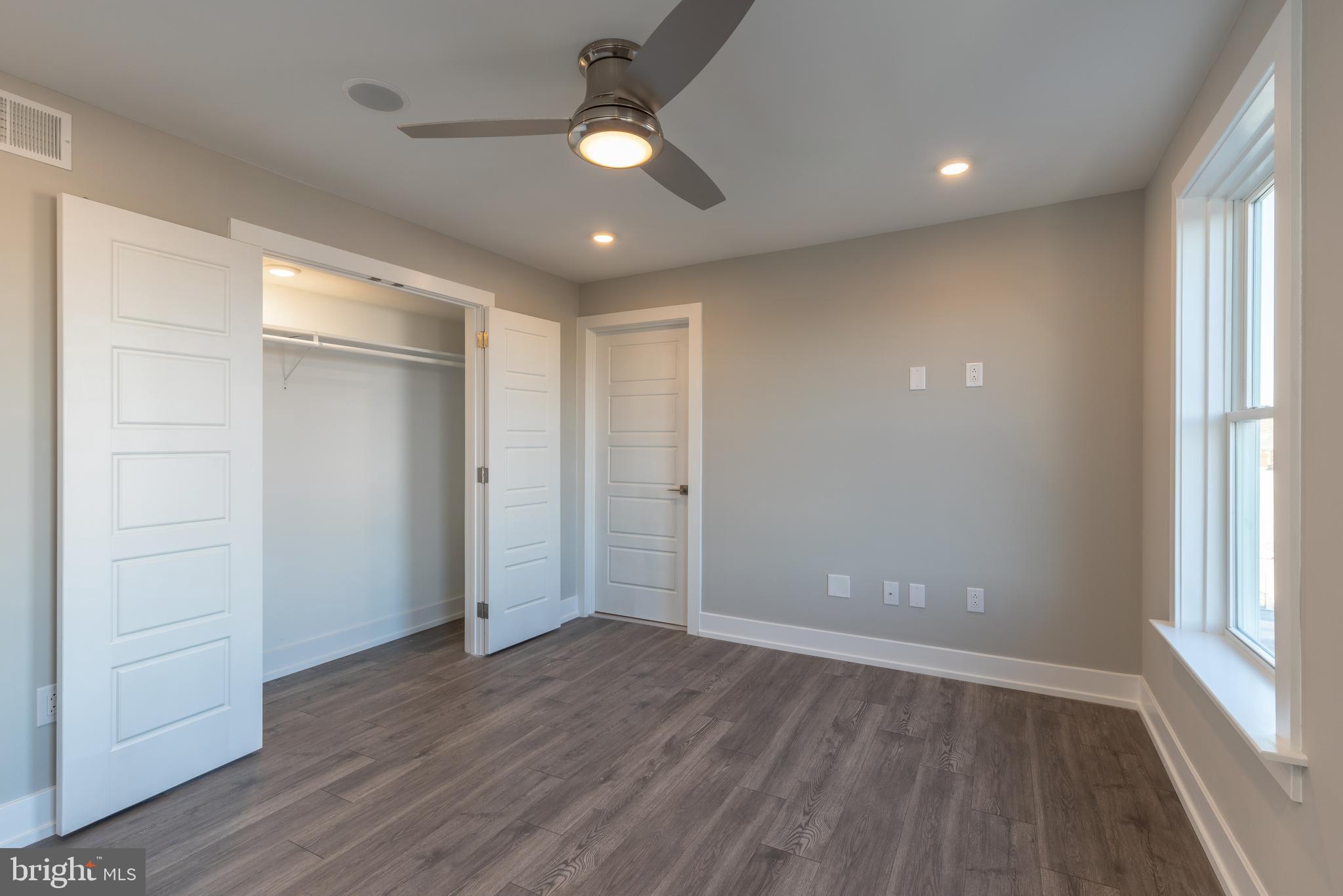 2517 Hope Street, Unit 5 Philadelphia, PA 19133 - Photo 20 of 35 an empty room with wooden floor and windows
