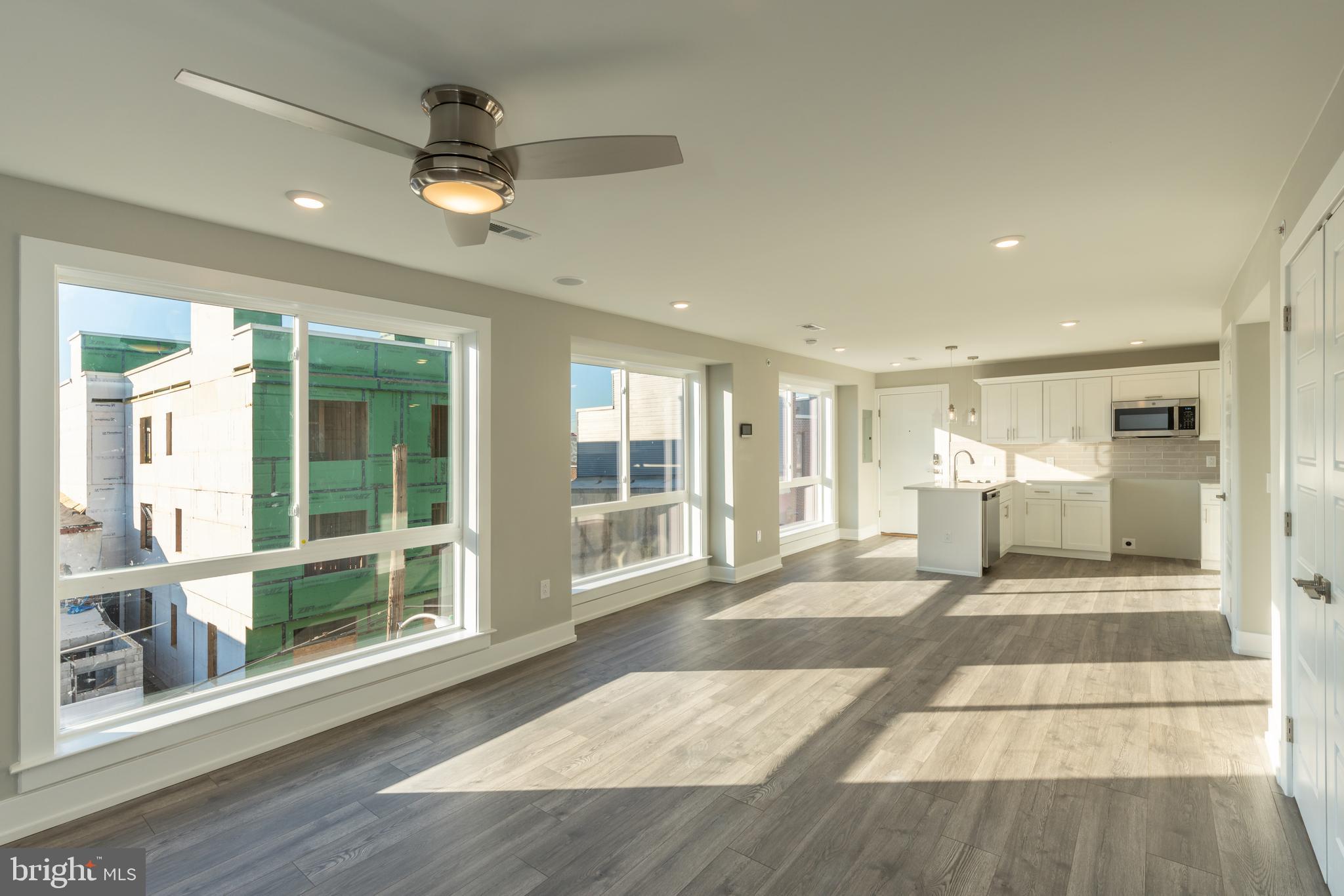 2517 Hope Street, Unit 5 Philadelphia, PA 19133 - Photo 6 of 35 a view of a livingroom with a furniture wooden floor and a window
