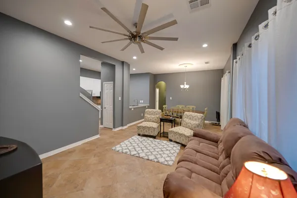 a living room with furniture and a chandelier
