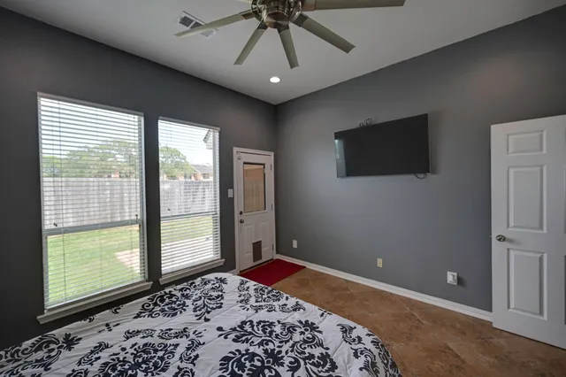 a bedroom with a bed and a television