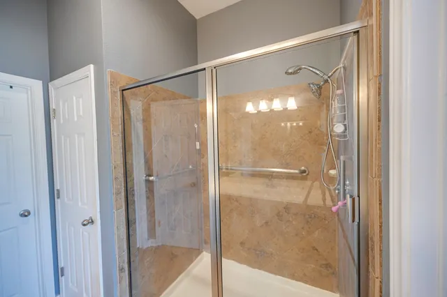 a bathroom with a glass shower door