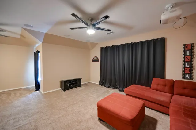 a bedroom with furniture and a ceiling fan