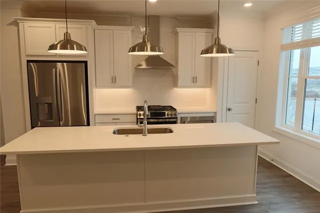 a kitchen with a sink a stove and a refrigerator