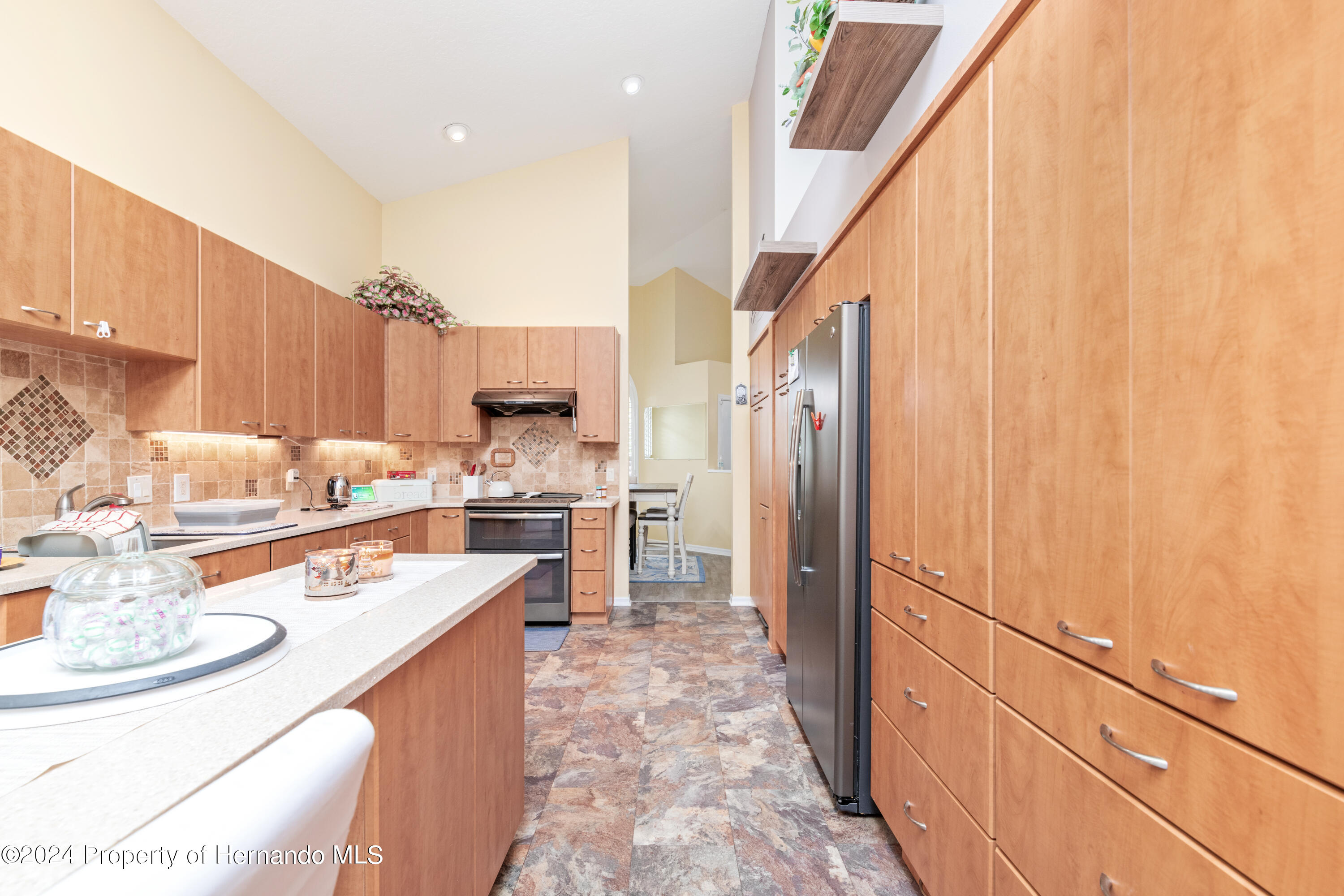 1 Byrsonima Loop Homosassa, FL 34446 - Photo 14 of 41 a kitchen with stainless steel appliances granite countertop a sink refrigerator and cabinets