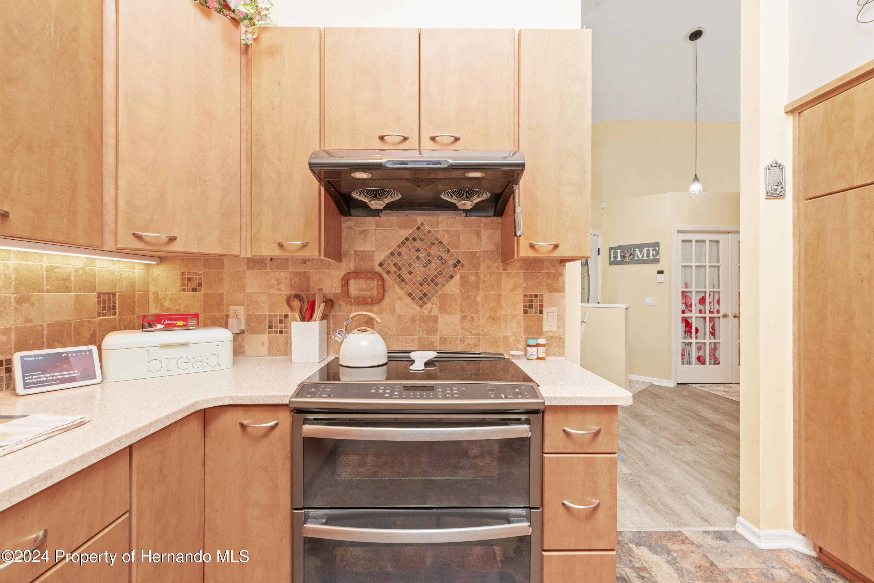 1 Byrsonima Loop Homosassa, FL 34446 - Photo 16 of 41 a kitchen with stainless steel appliances granite countertop a stove and a refrigerator with white cabinets