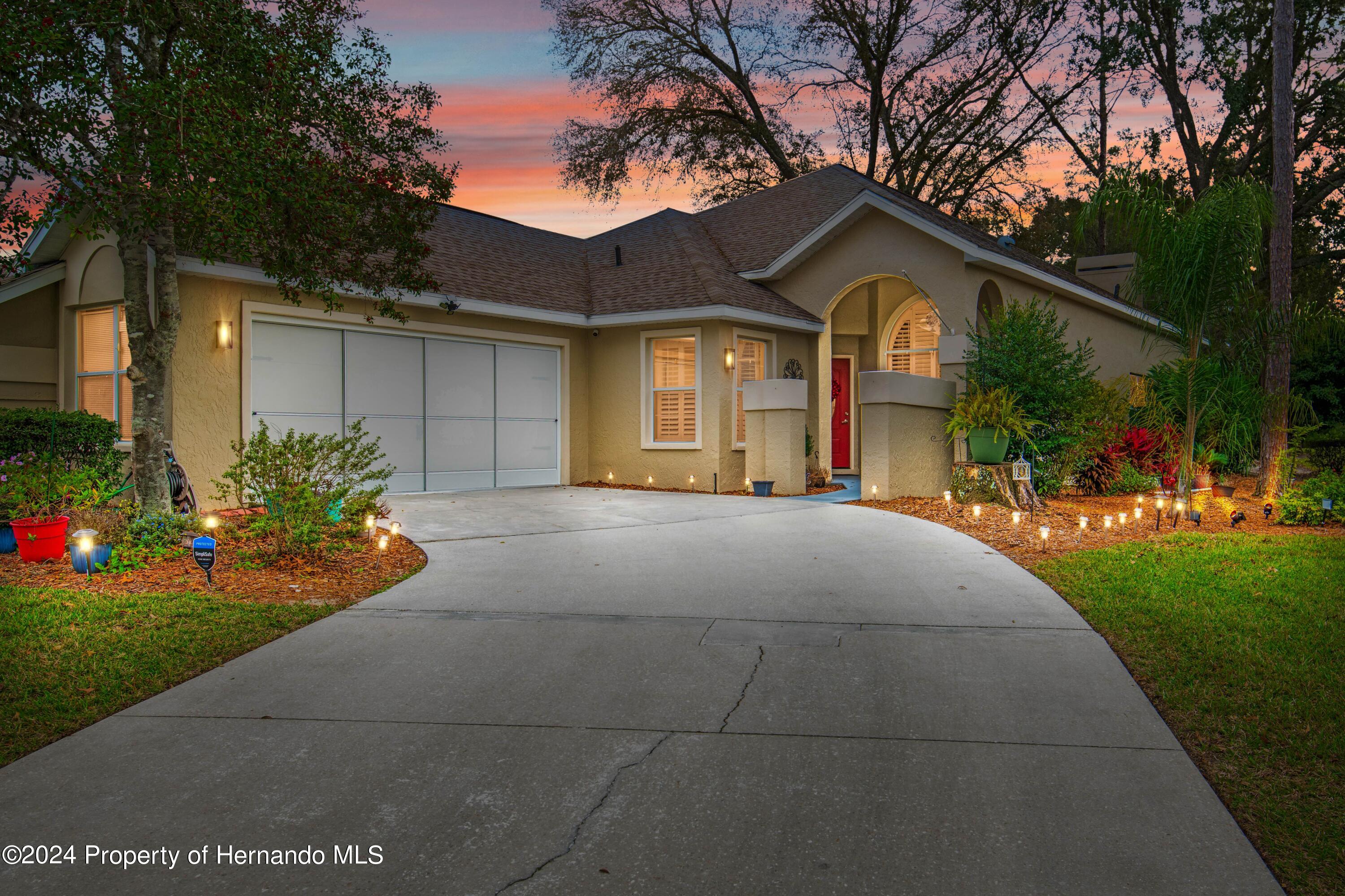 1 Byrsonima Loop Homosassa, FL 34446 - Photo 2 of 41 a front view of a house with a yard and garage