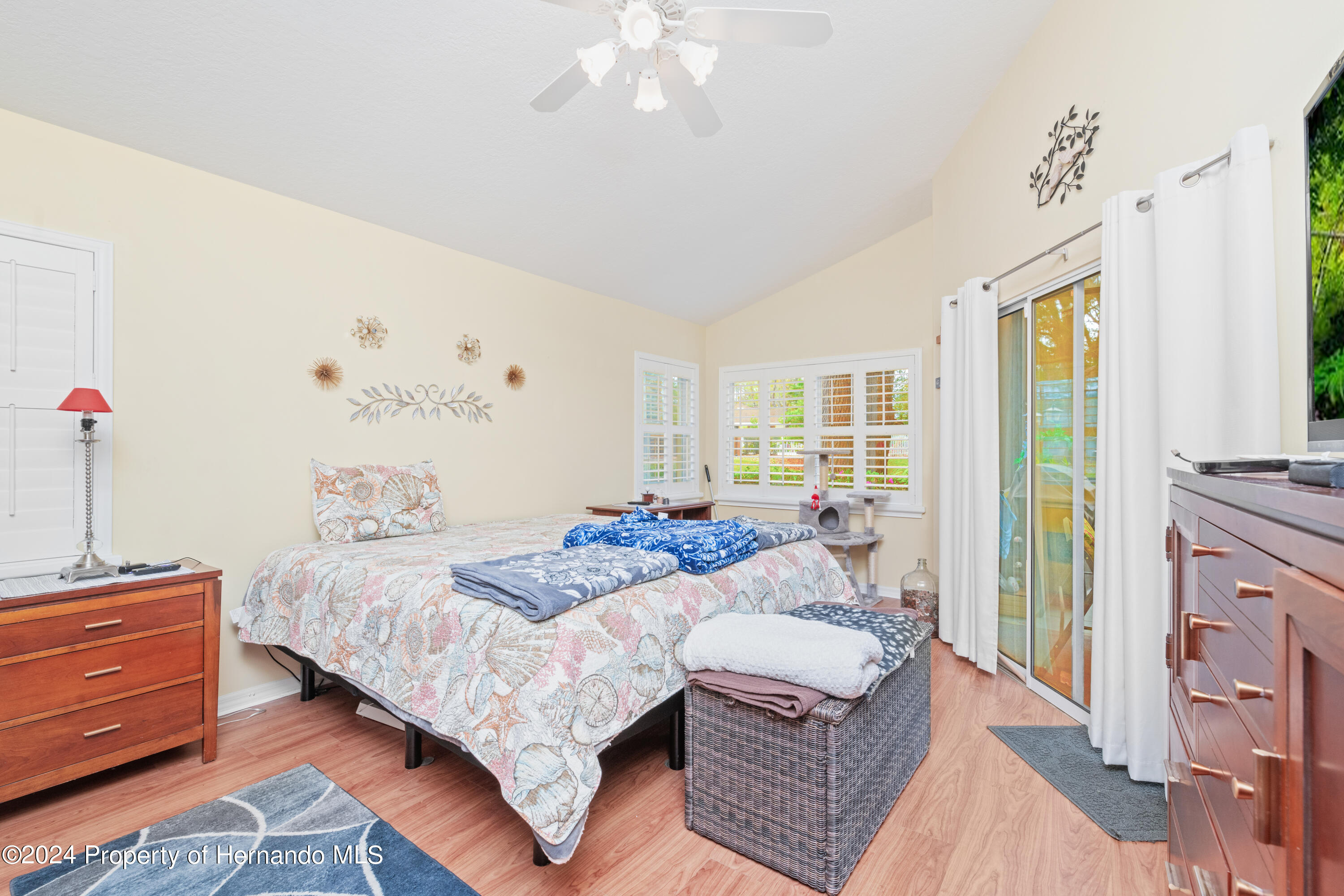 1 Byrsonima Loop Homosassa, FL 34446 - Photo 27 of 41 a bedroom with a bed wooden floor and window