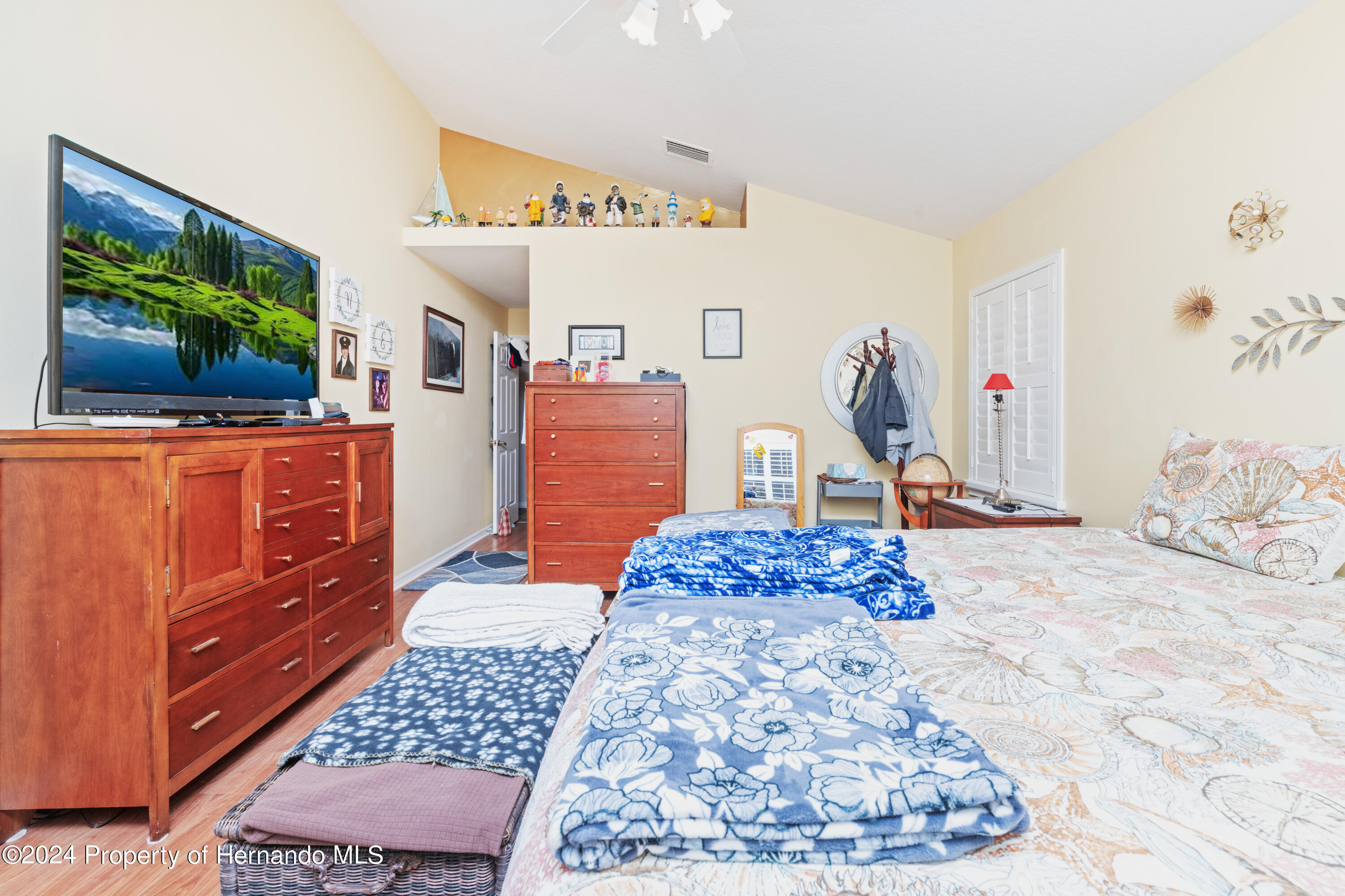 1 Byrsonima Loop Homosassa, FL 34446 - Photo 30 of 41 a bedroom with a bed and flat screen tv