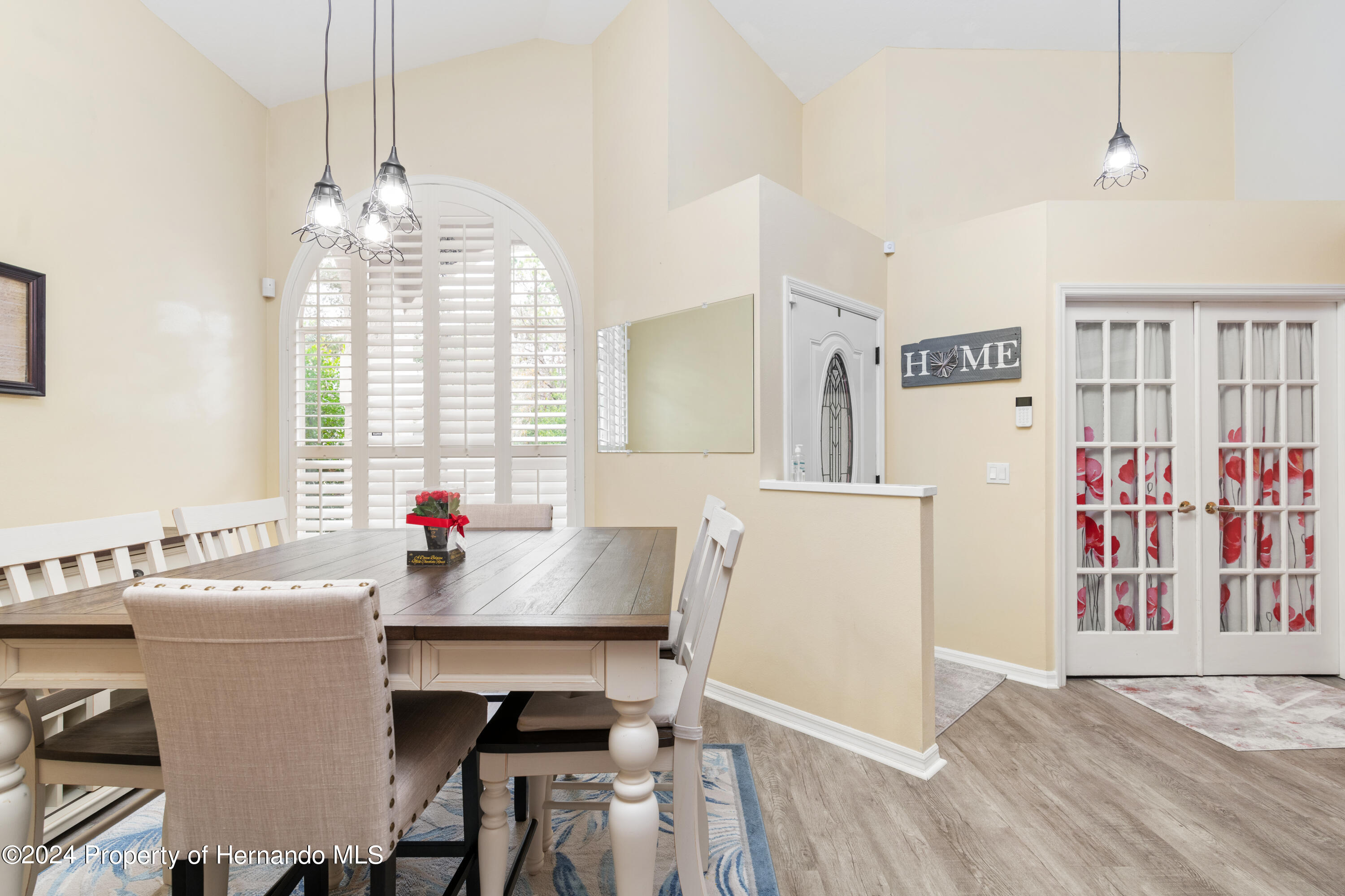 1 Byrsonima Loop Homosassa, FL 34446 - Photo 5 of 41 a kitchen with a refrigerator a sink dishwasher a dining table and chairs with wooden floor