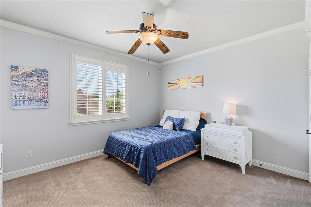 476 Hidden Valley Lane Coppell, TX 75019 - Photo 21 of 40 a bedroom with a bed and a chandelier