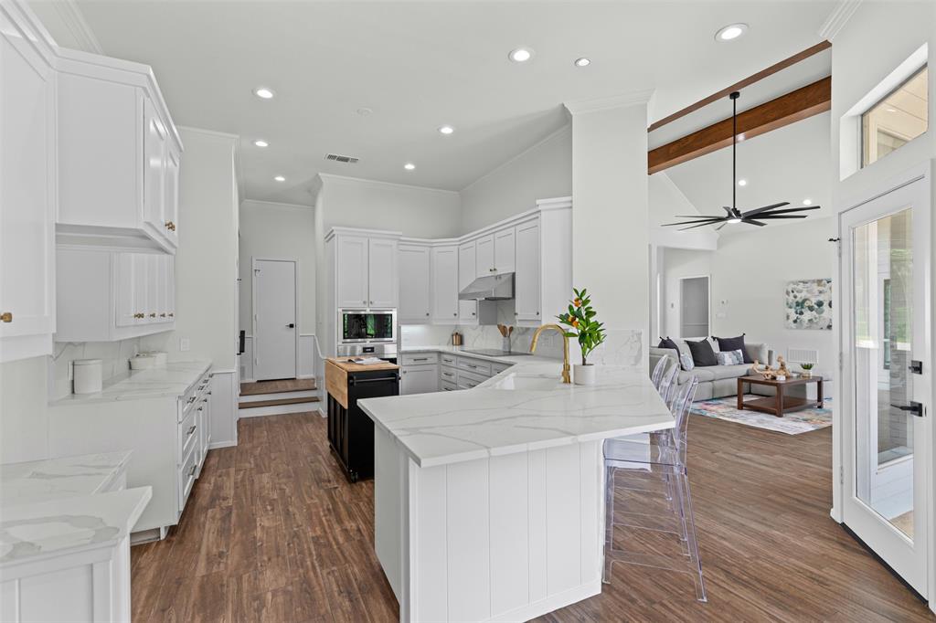 2109 Greta Lane Fort Worth, TX 76120 - Photo 12 of 40 a large kitchen with kitchen island a stove a sink a refrigerator and wooden floor