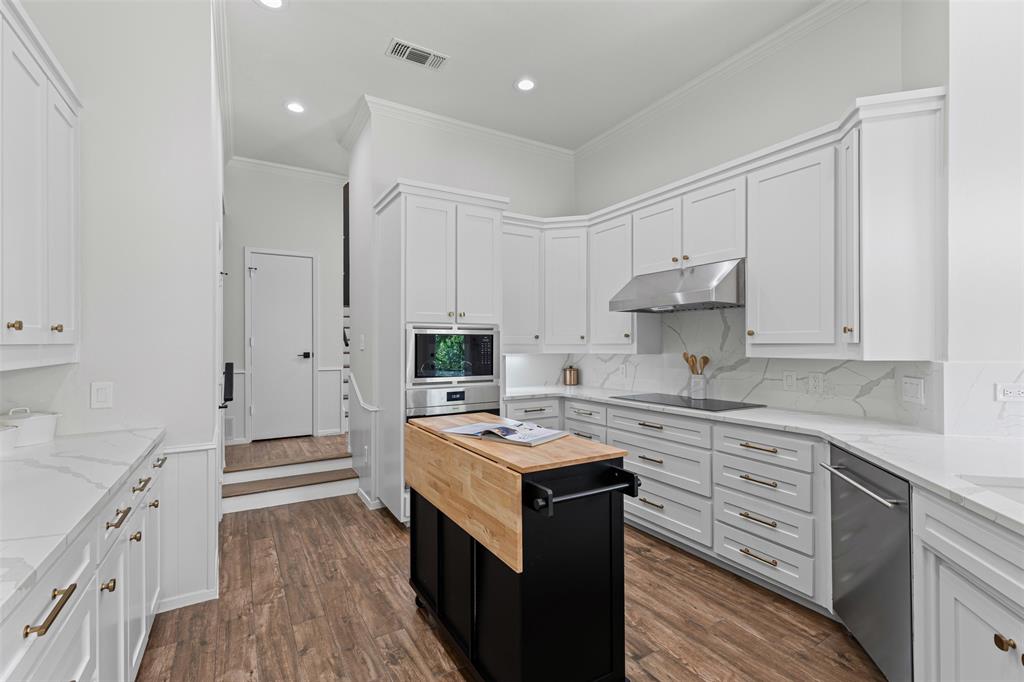 2109 Greta Lane Fort Worth, TX 76120 - Photo 14 of 40 a kitchen with cabinets appliances a sink and a counter space