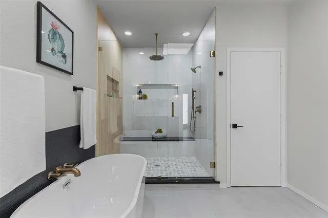 a bathroom with a tub shower and sink