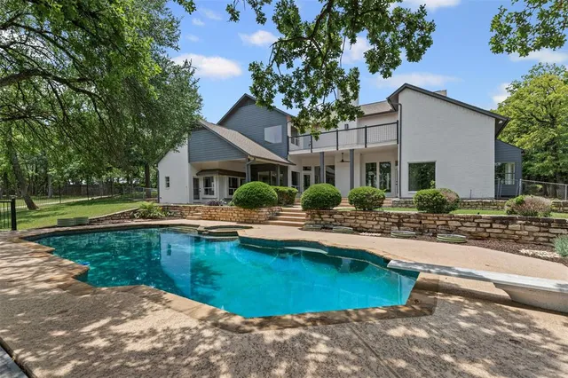 a house with swimming pool in front of it