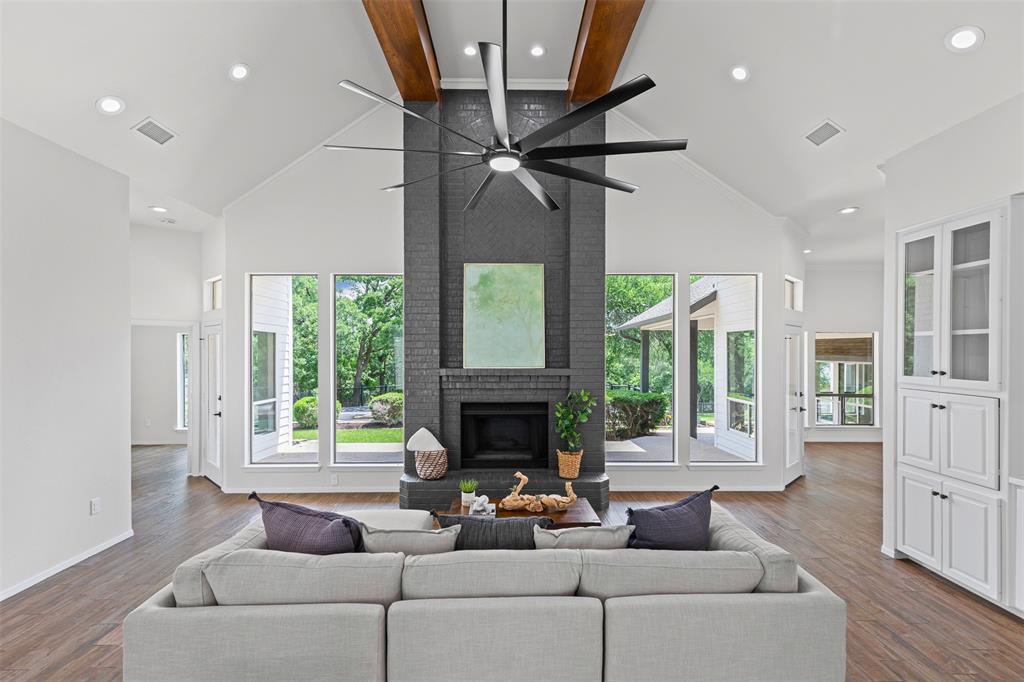 2109 Greta Lane Fort Worth, TX 76120 - Photo 6 of 40 a living room with furniture a fireplace and a floor to ceiling window