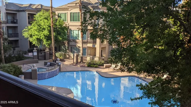 a view of a house with fountain and potted plants