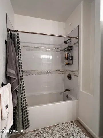 a bathroom with a bathtub a toilet and a shower