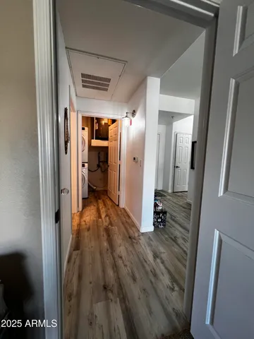 a view of a hallway with wooden floor and staircase