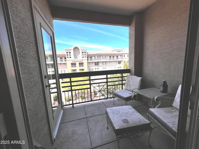 a view of a balcony with chair and table