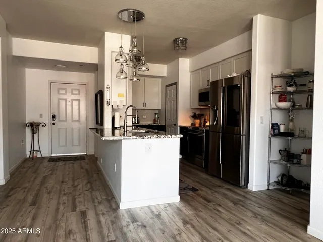 a kitchen with a refrigerator and a stove top oven