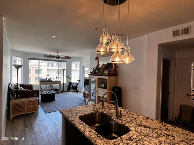 a kitchen with sink table and chairs