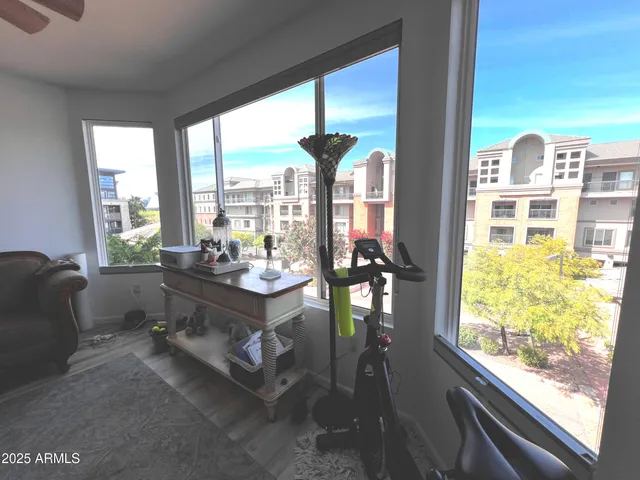a living room with furniture tv and a large window