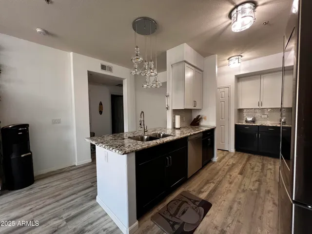 a large kitchen with a stove and cabinets