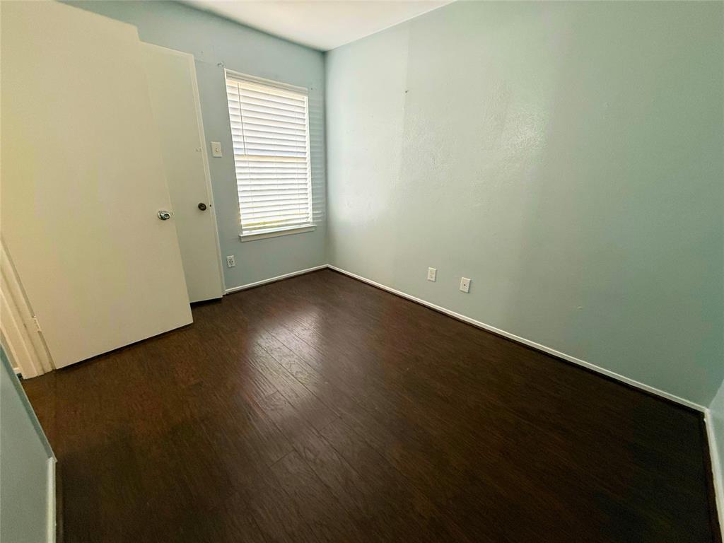 11311 Audelia Road, Unit 161 Dallas, TX 75243 - Photo 11 of 15 Unfurnished bedroom with dark wood-type flooring and baseboards