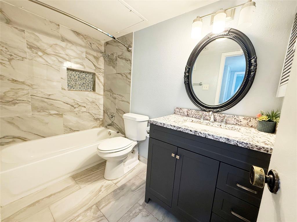 11311 Audelia Road, Unit 161 Dallas, TX 75243 - Photo 13 of 15 Full bath featuring tub / shower combination, vanity, and light marble finish flooring