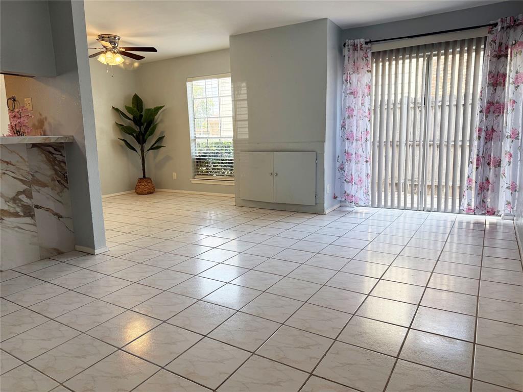 11311 Audelia Road, Unit 161 Dallas, TX 75243 - Photo 2 of 15 Unfurnished room featuring a ceiling fan and light tile patterned floors