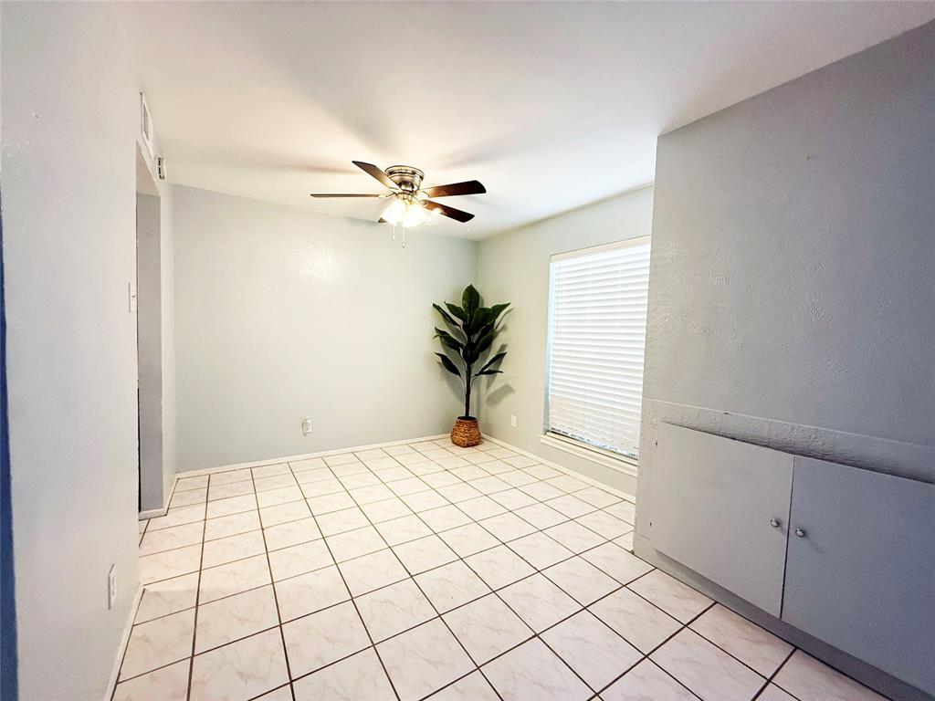 11311 Audelia Road, Unit 161 Dallas, TX 75243 - Photo 8 of 15 Spare room with a ceiling fan and light tile patterned floors