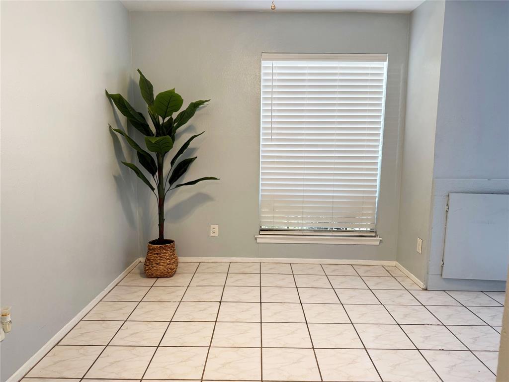 11311 Audelia Road, Unit 161 Dallas, TX 75243 - Photo 9 of 15 Unfurnished room with light tile patterned floors and baseboards