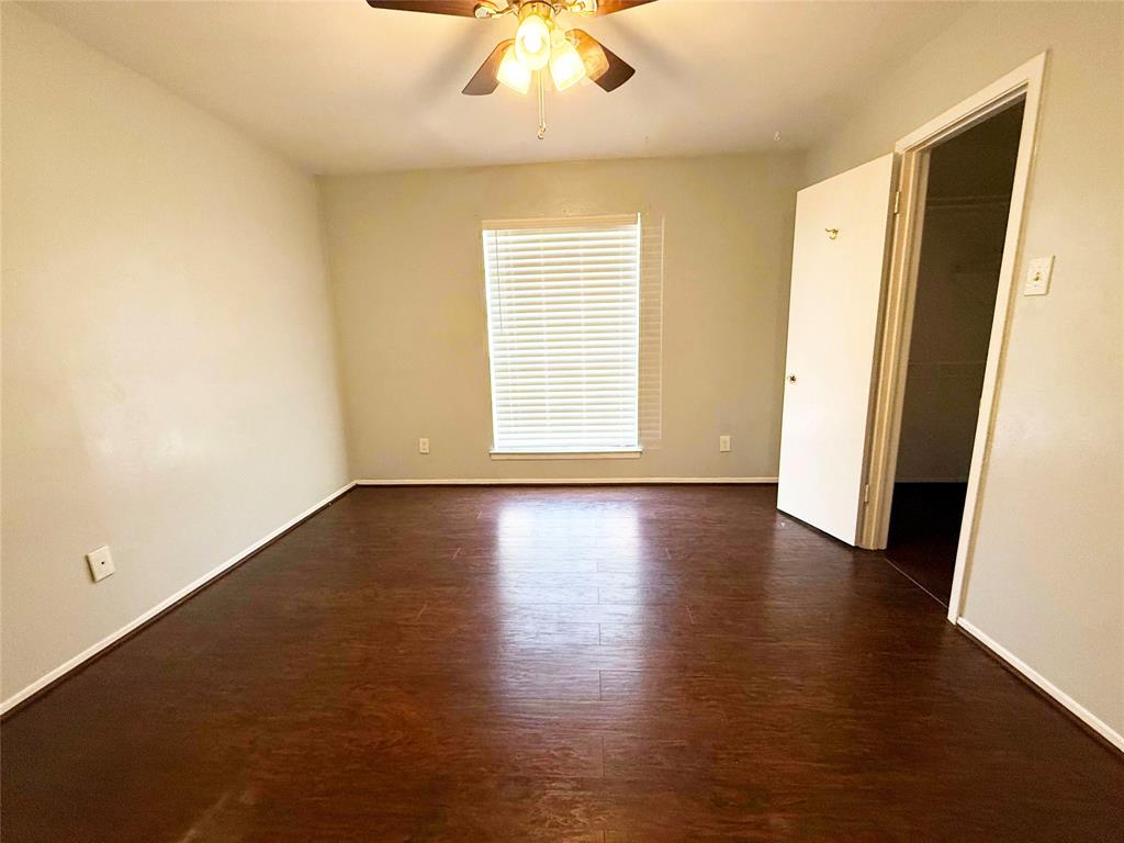 11311 Audelia Road, Unit 161 Dallas, TX 75243 - Photo 10 of 15 Spare room with dark wood-style flooring and ceiling fan