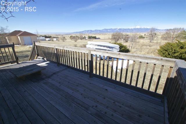 11875 Smith Road Peyton, CO 80831 - Photo 24 of 26 Great wood deck overlooks the front range