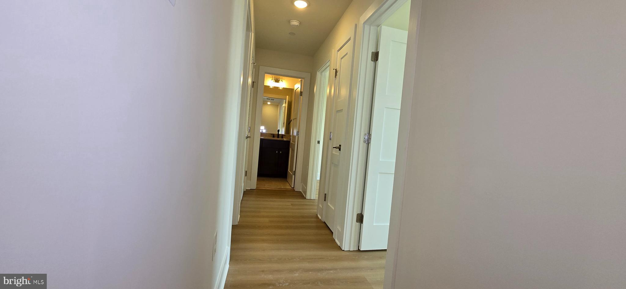 412 Chapel Alley, Unit 1 Frederick, MD 21701 - Photo 20 of 41 a view of a hallway with wooden floor