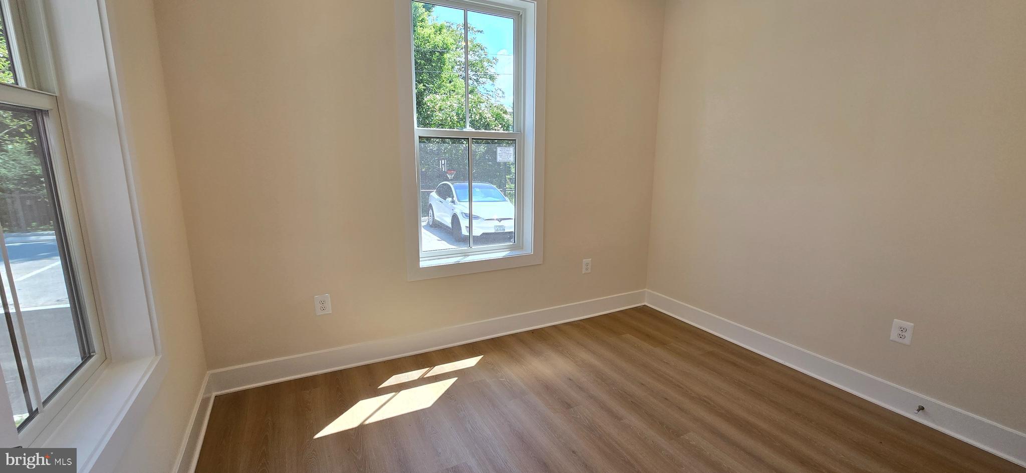 412 Chapel Alley, Unit 1 Frederick, MD 21701 - Photo 5 of 41 an empty room with wooden floor and windows