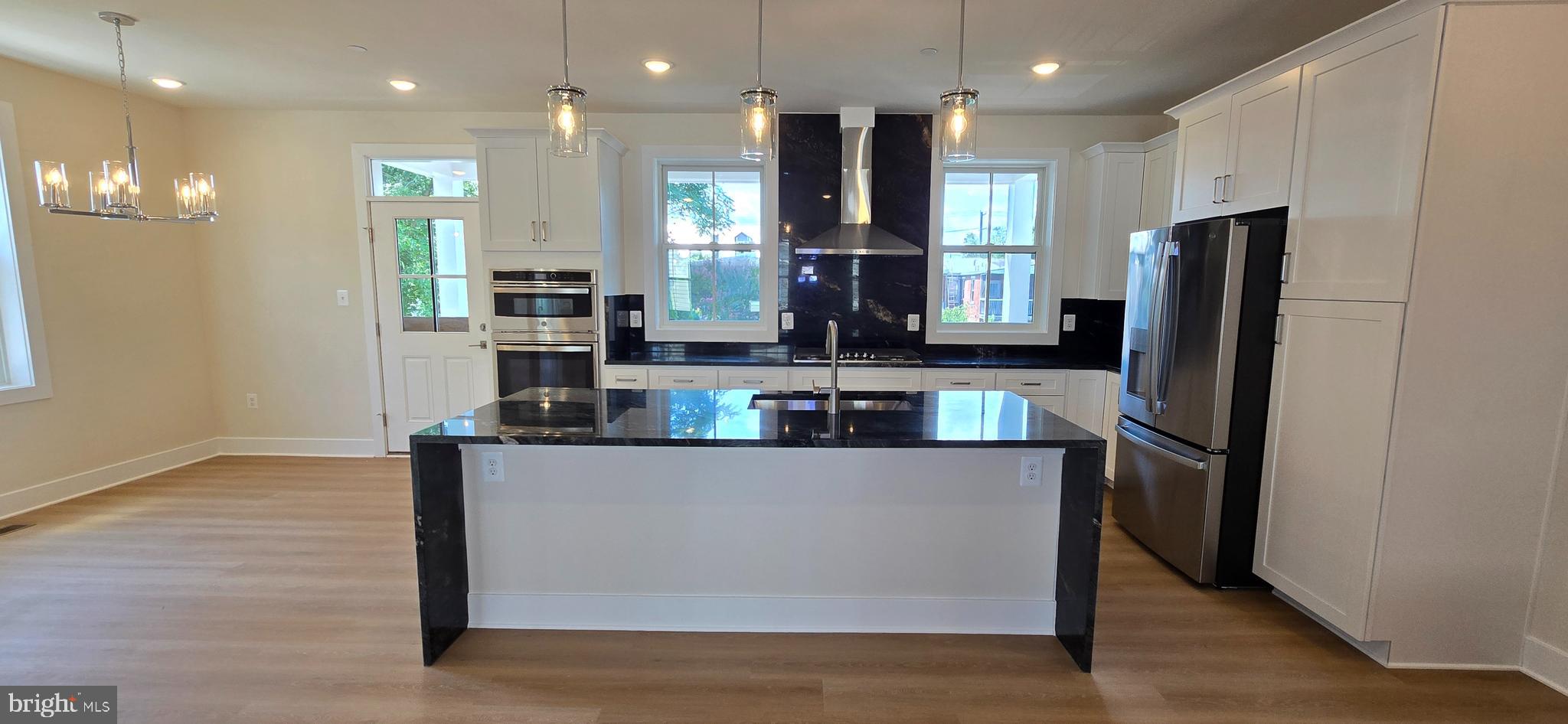 412 Chapel Alley, Unit 1 Frederick, MD 21701 - Photo 10 of 41 a kitchen with stainless steel appliances granite countertop a refrigerator a sink and a stove