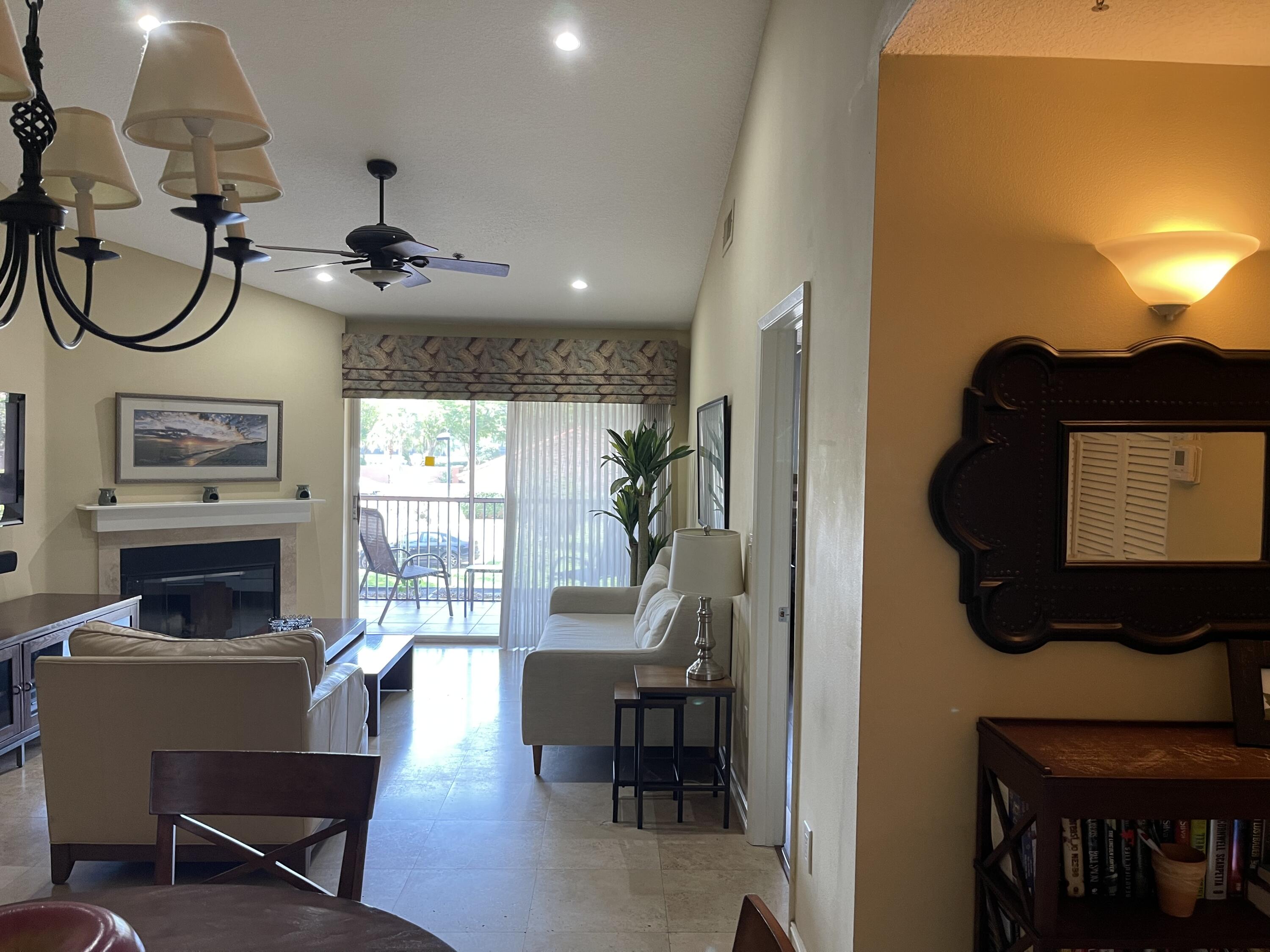 3111 Clint Moore Road, Unit 205 Boca Raton, FL 33496 - Photo 14 of 35 a living room with furniture and a fireplace
