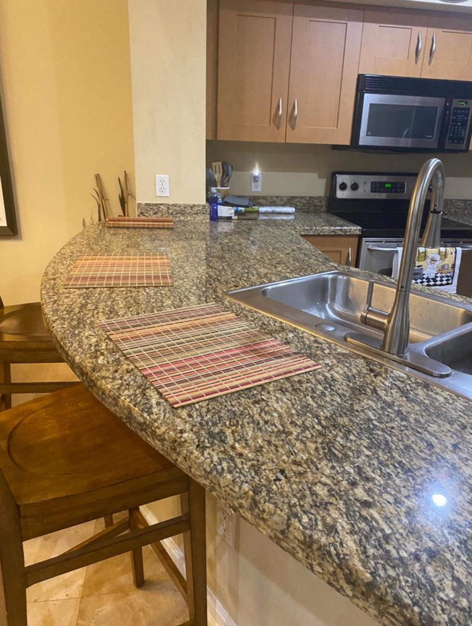 3111 Clint Moore Road, Unit 205 Boca Raton, FL 33496 - Photo 23 of 35 a view of a kitchen with kitchen island and a sink