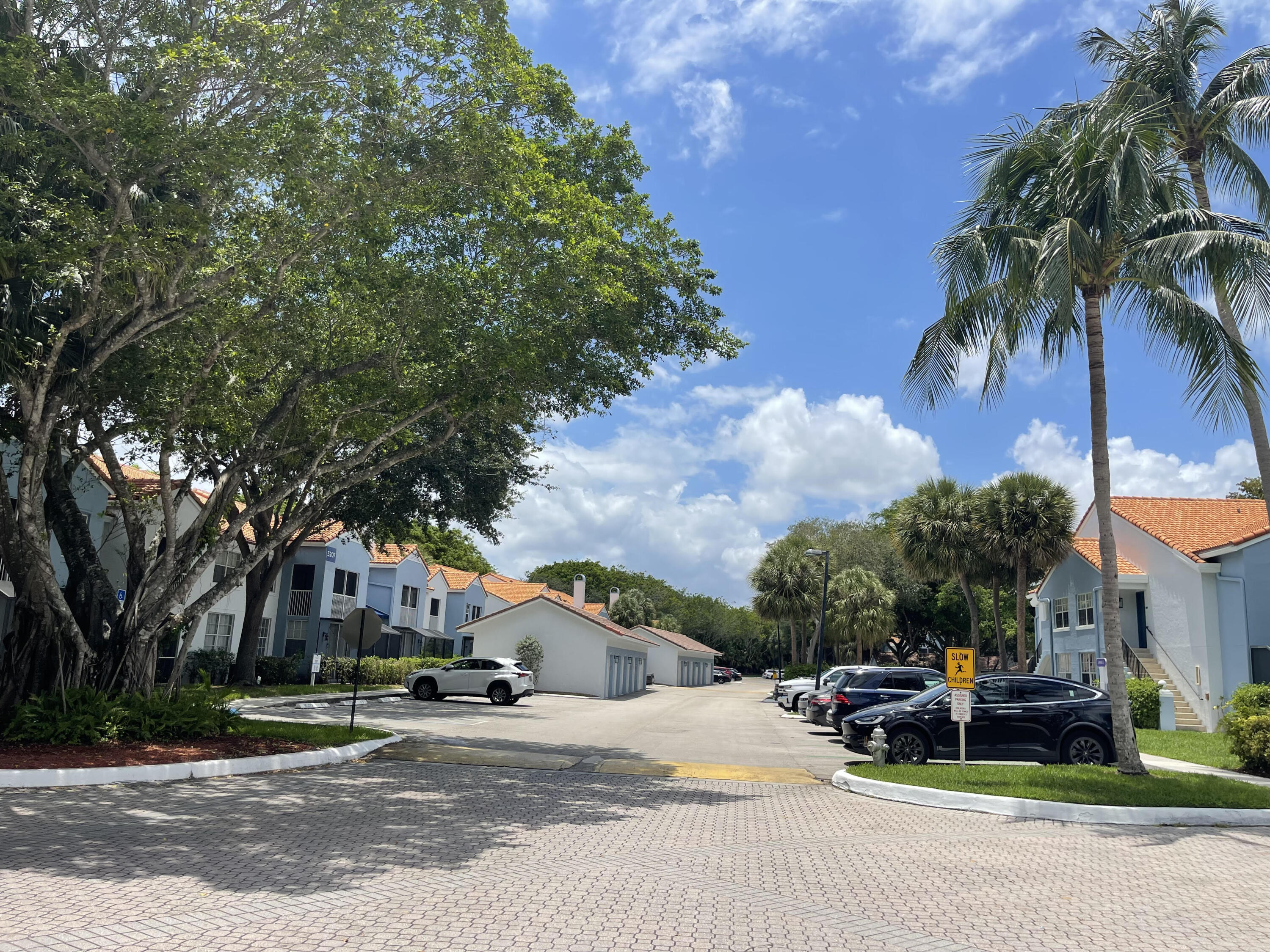 3111 Clint Moore Road, Unit 205 Boca Raton, FL 33496 - Photo 5 of 35 a car parked on the side of the street