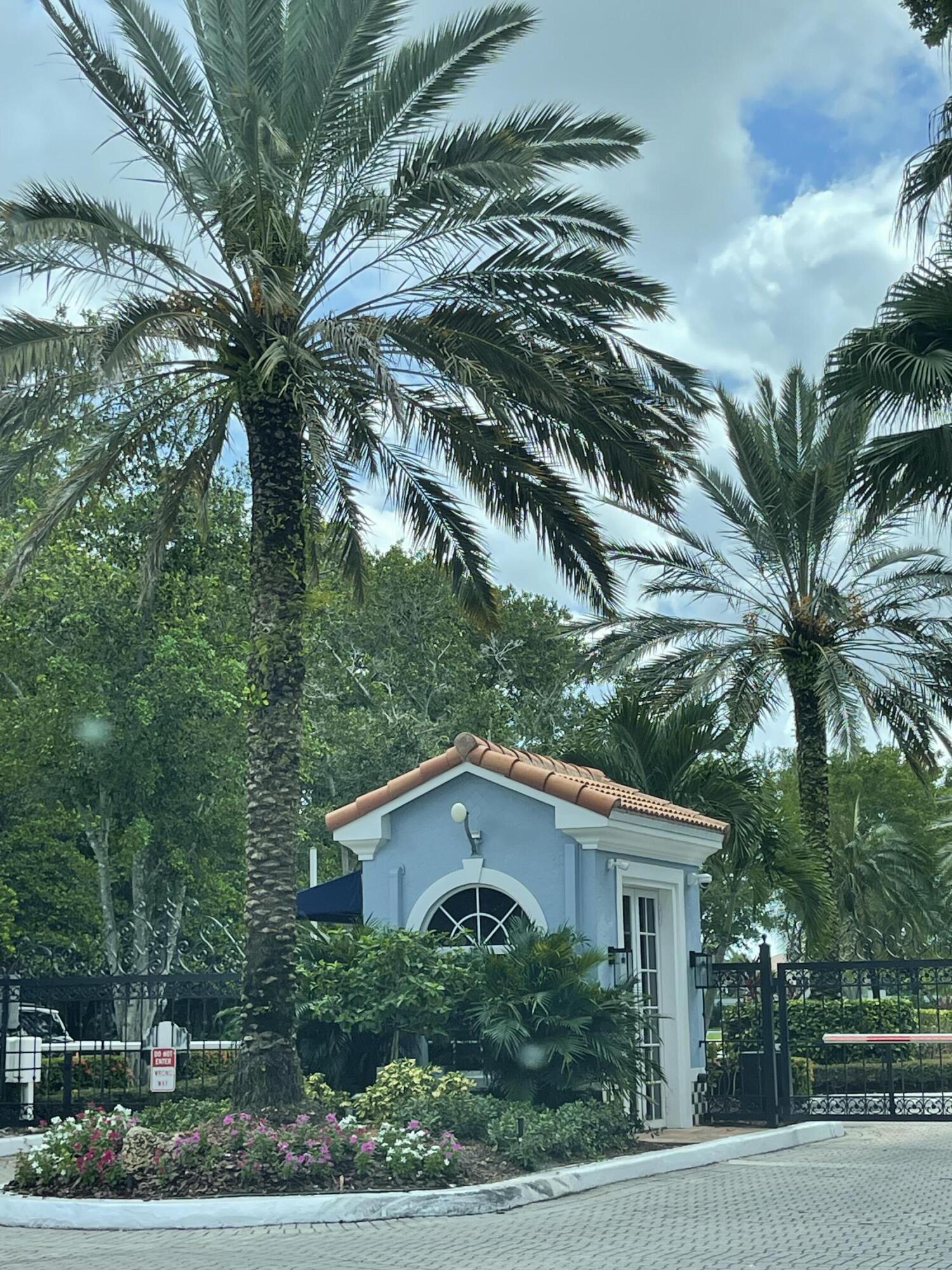 3111 Clint Moore Road, Unit 205 Boca Raton, FL 33496 - Photo 9 of 35 a view of a yard in front of a house with a tree