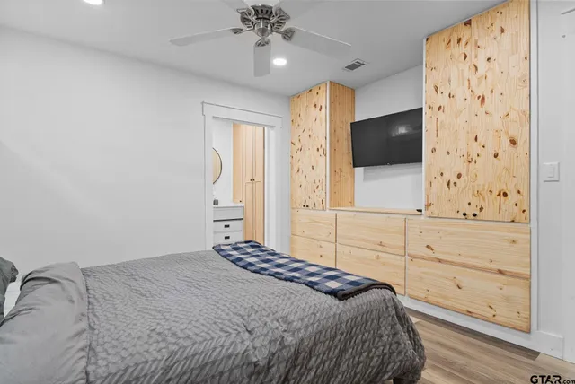 a bedroom with a bed and a flat screen tv