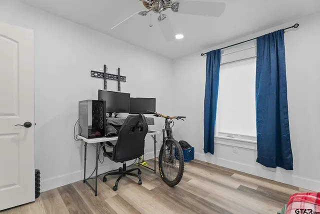 a view of a workspace with furniture and wooden floor
