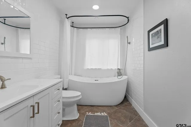 a bathroom with a toilet a sink and bathtub