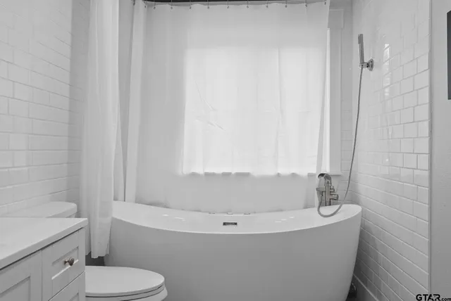 a bathroom with a bathtub and toilet