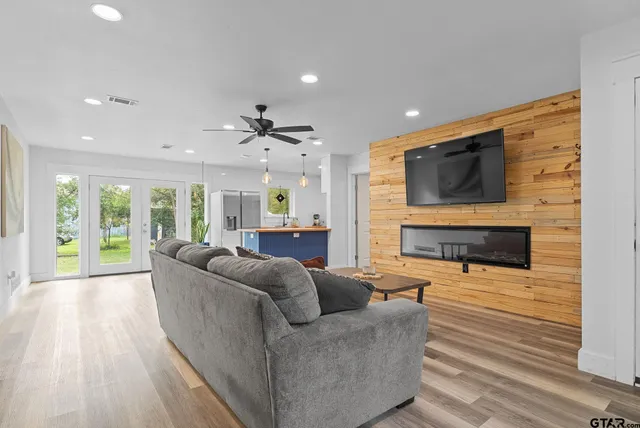 a living room with furniture a flat screen tv and a fireplace