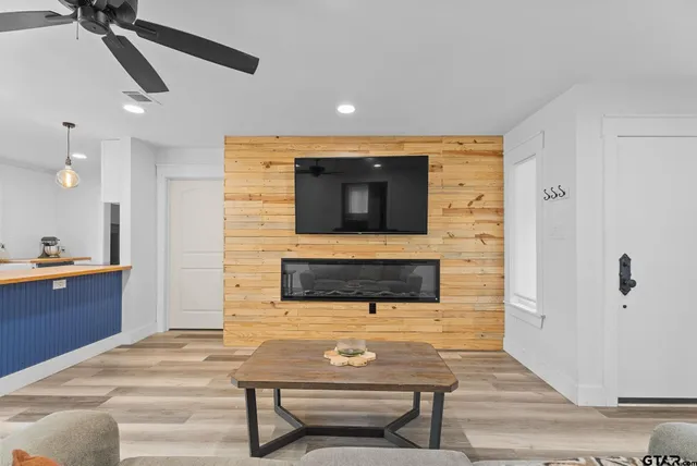 a living room with furniture and a wooden floor