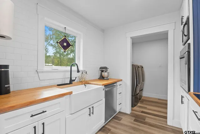 a view of a kitchen with a sink and a refrigerator